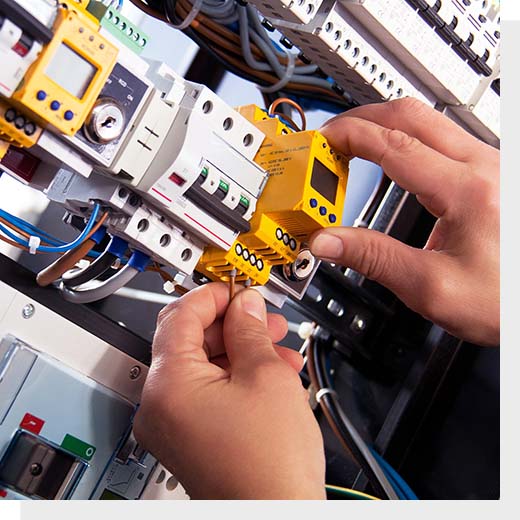 A pair of hands adjusting part of a switchboard